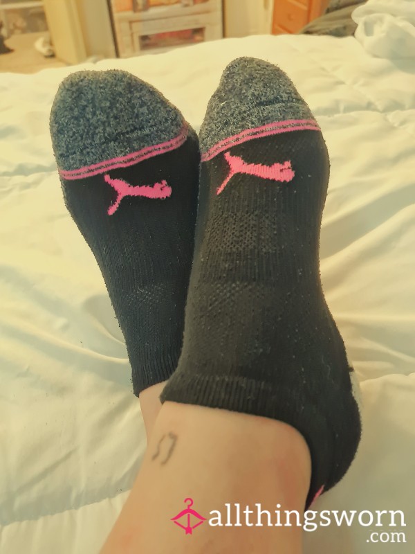 Playful Edge: Worn Black, Grey, And Pink Puma Ankle Socks