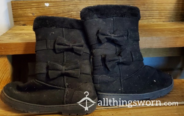 Worn Black Fuzzy Boots With Bows